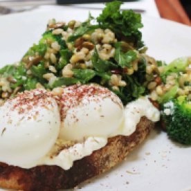 Superfood breakfast! Avocado, kale, broccoli flowerette, barley, mung sprouts, green chilli and pumpkin seeds on toast with light cottage cheese and free range eggs (AUD 18.50)