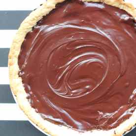 Once the tart is ready, let it cool down for a while then pour the chocolate mixture over it. Leave it to cool and place into the fridge to chill for at least 2-3hr.